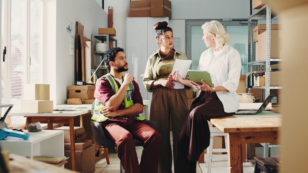 Business owner meeting with employees to discuss workplace policies and payroll processes, supporting businesses in avoiding Fair Work mistakes and maintaining compliance.